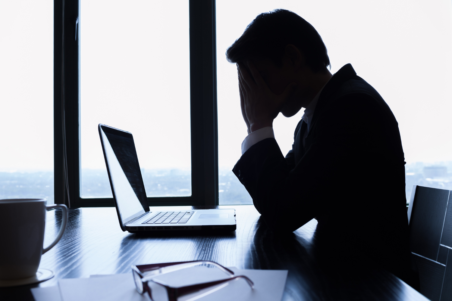 A frustrated and stressed business owner on his desk.