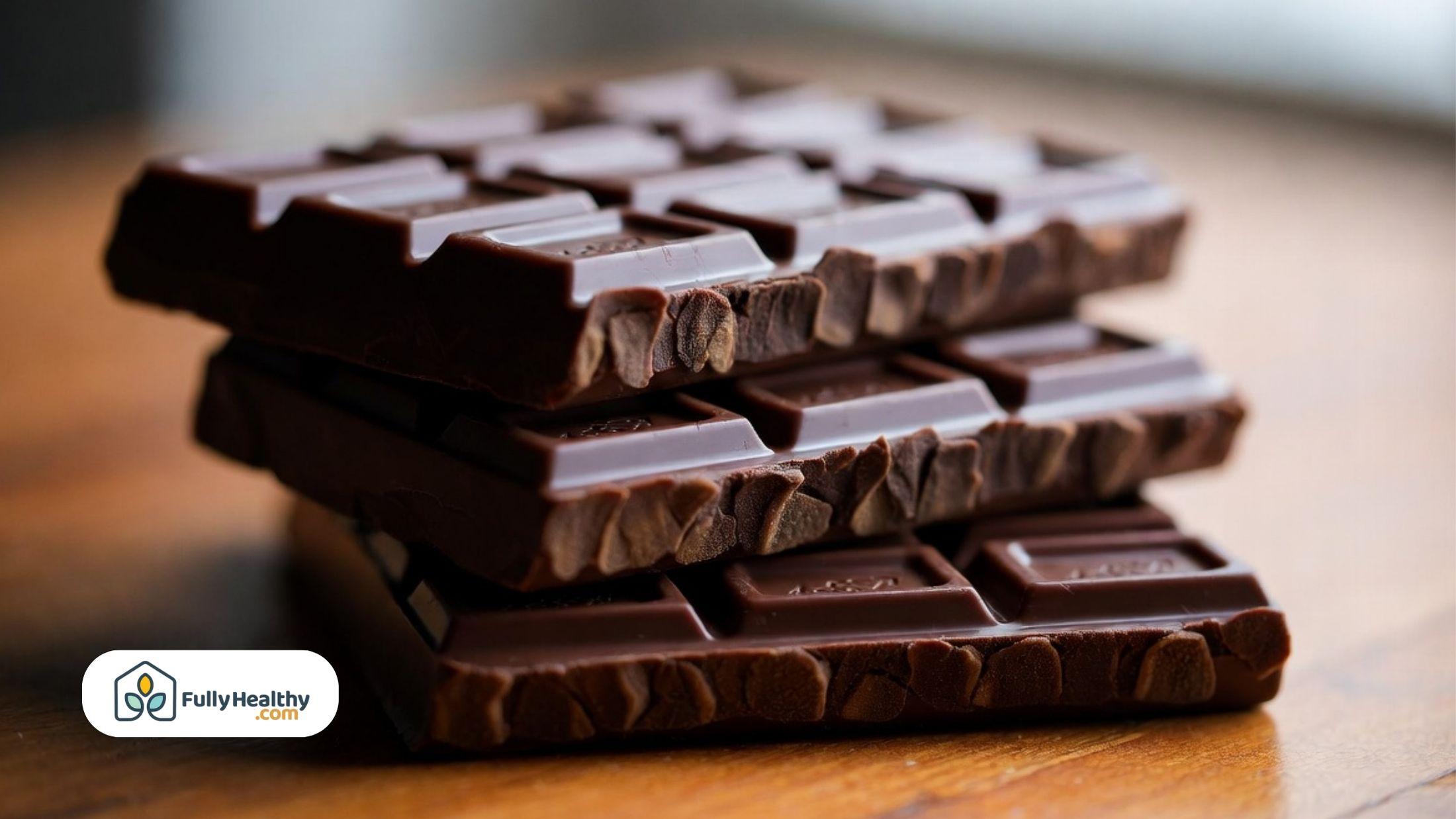 Stacked dark chocolate bars highlighting rich texture and visible cocoa pieces.