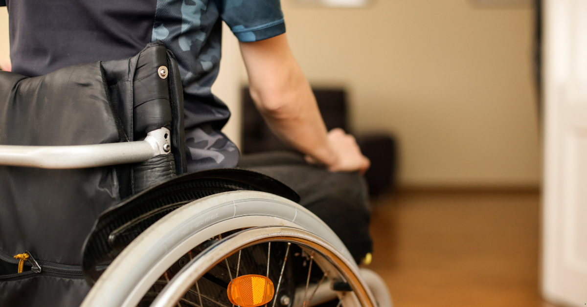 A Disabled Person is Sitting on a Wheelchair in his NDIS Property in Queensland