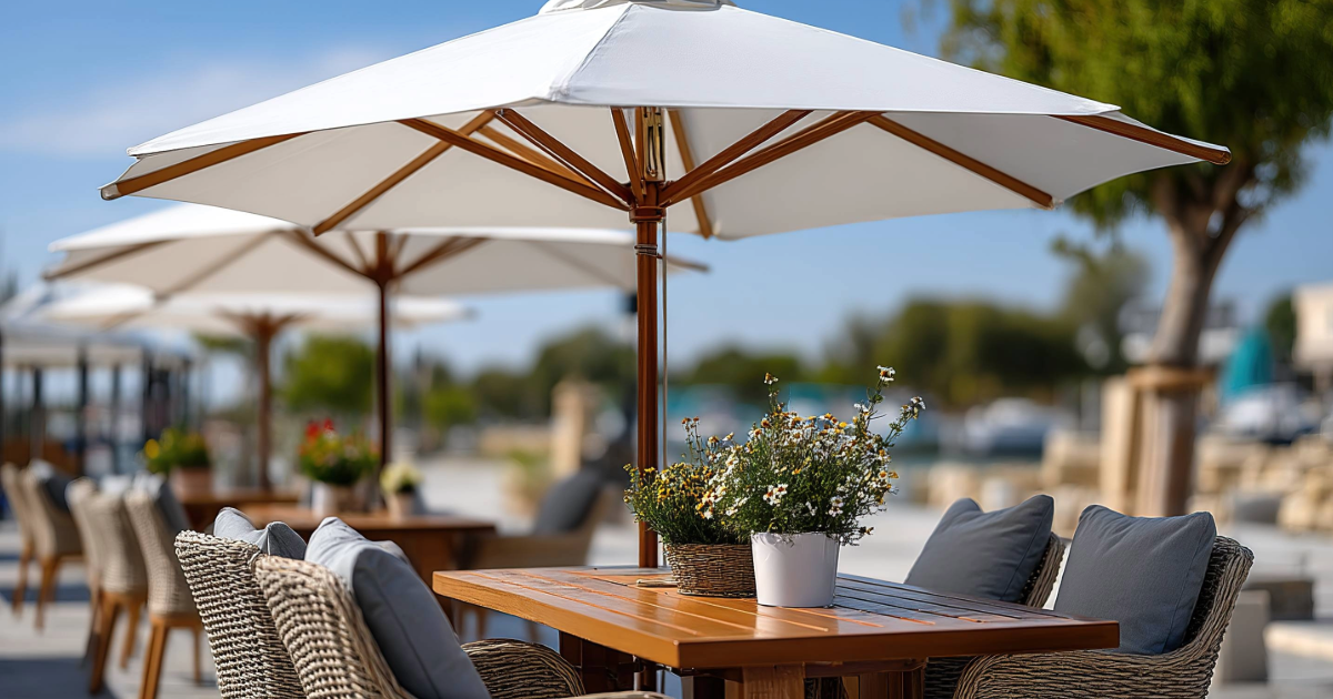 Outdoor waterfront dining with wicker chairs and umbrellas, perfect for relaxing near New Jersey Shore bayfront rentals.