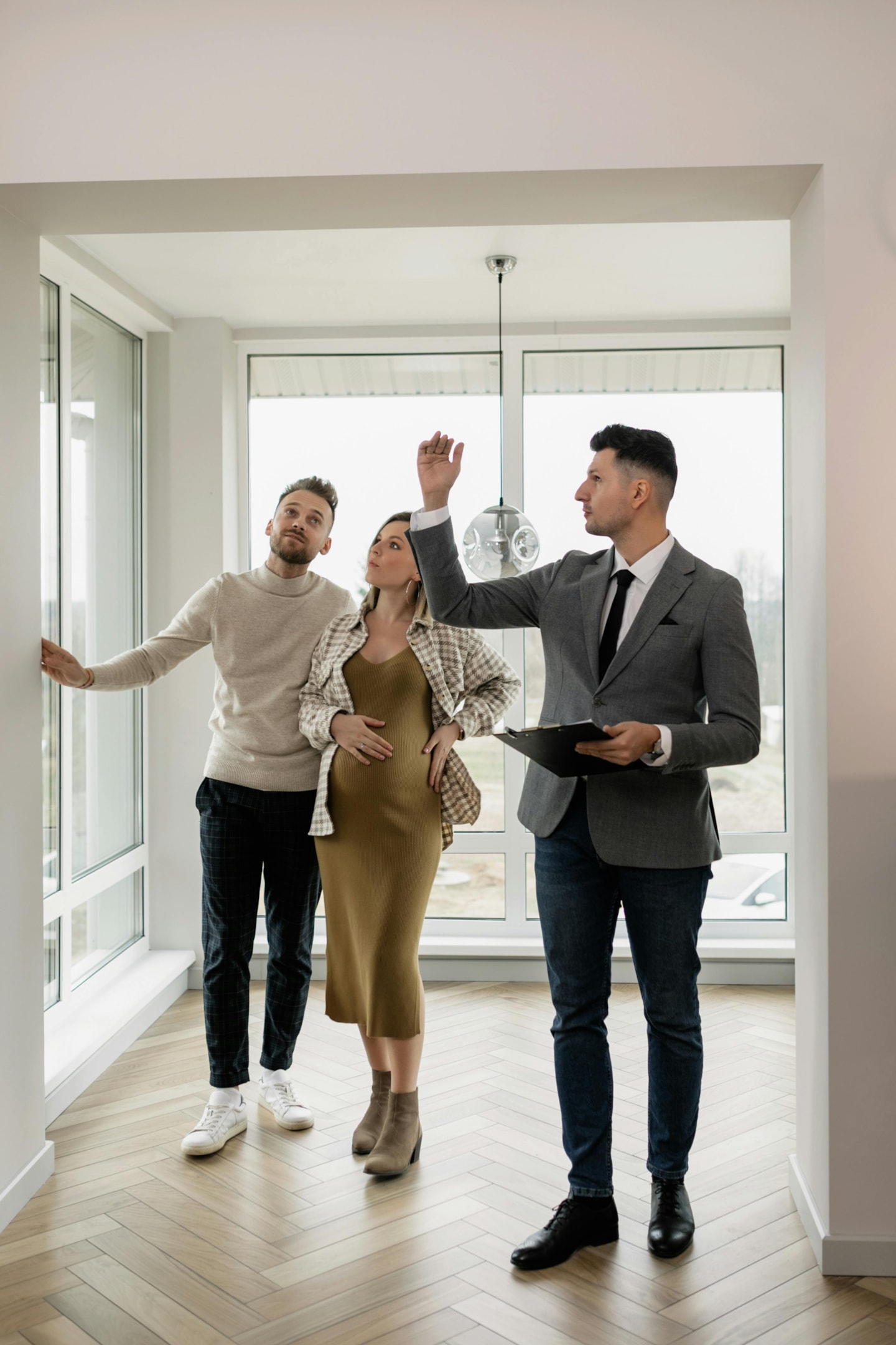 Real estate agent shows house to potential buyers.