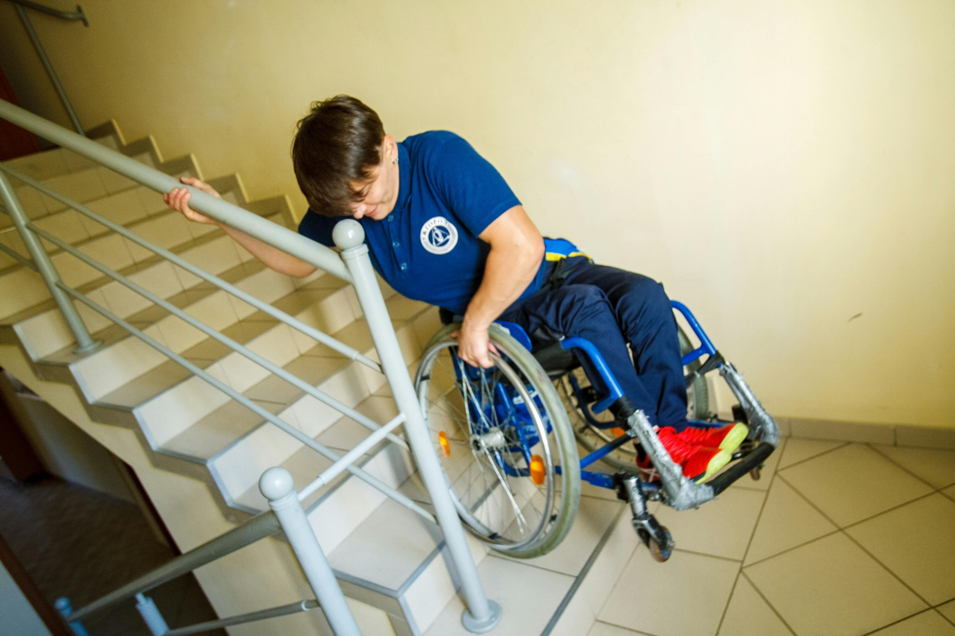 A stair stretcher helping patient descend stairs in a bulding without elevators.