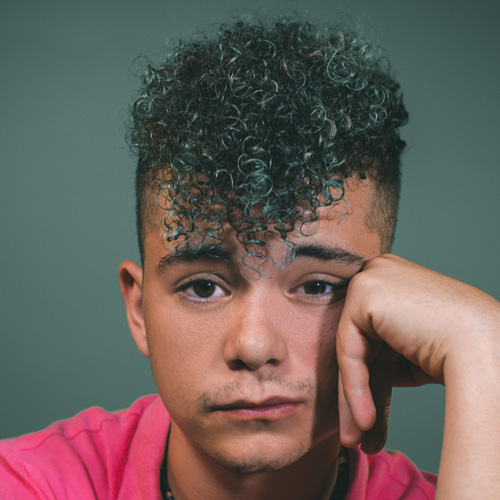 guy with type 3c curls and shaved sides 
