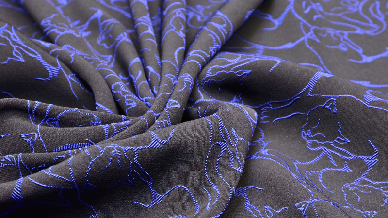 A close up of a blue and black print rayon fabric