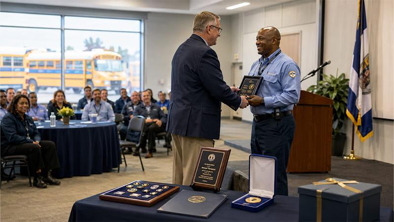 Bus driver receiving a service award during a transportation team recognition ceremony