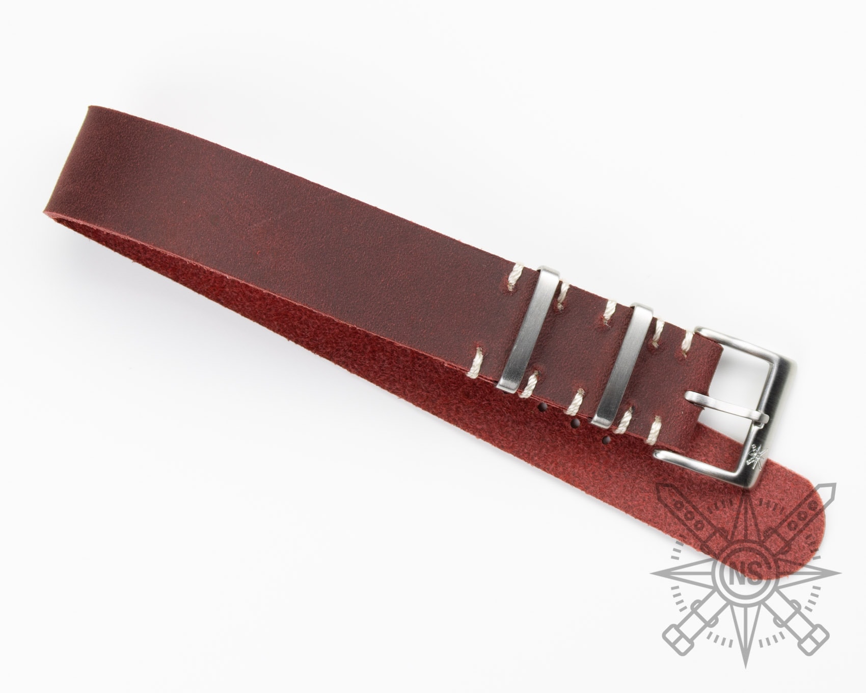 Crocodile embossed leather watch straps in red on a display.