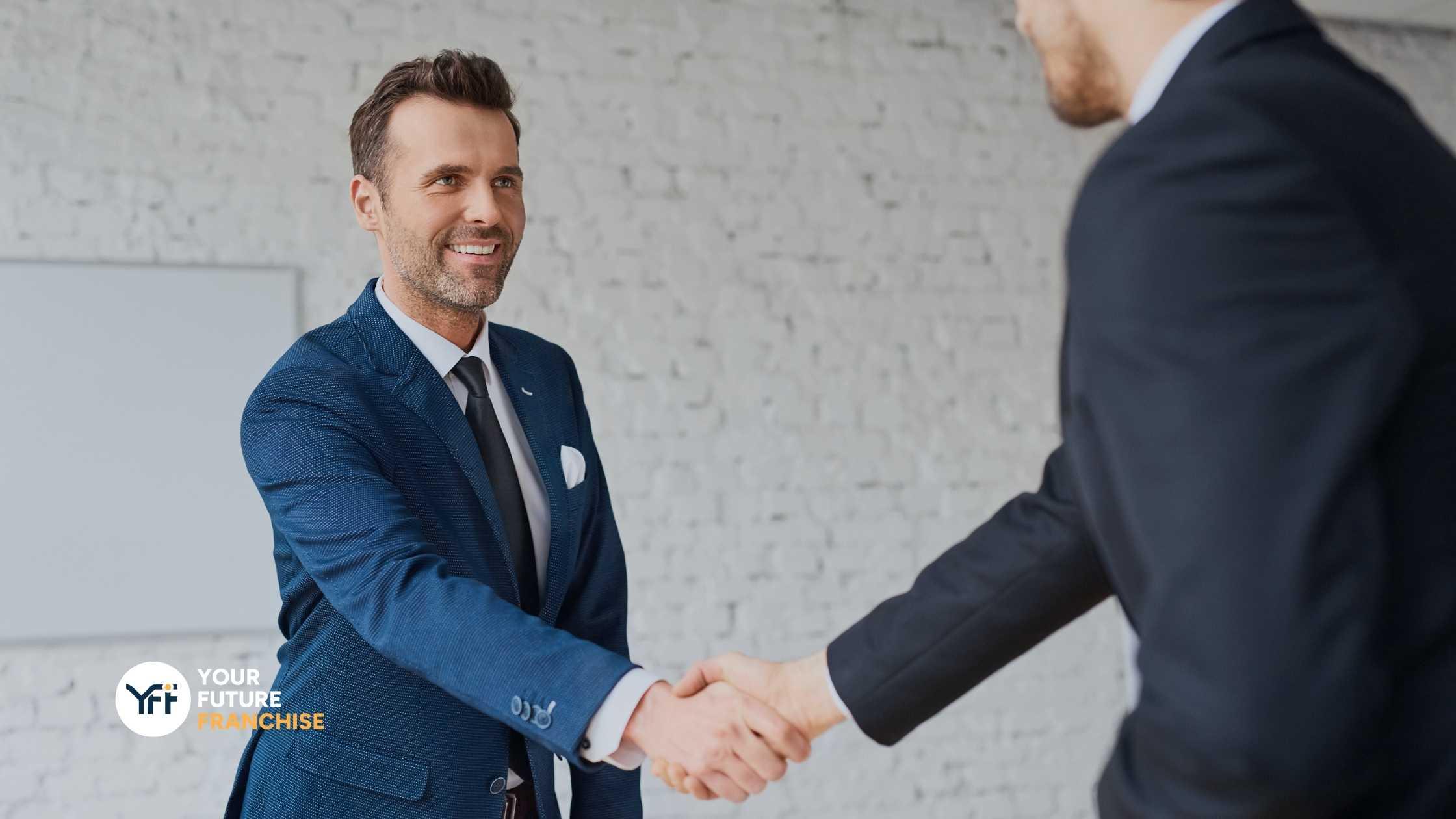A businessman shaking hands with another businessman