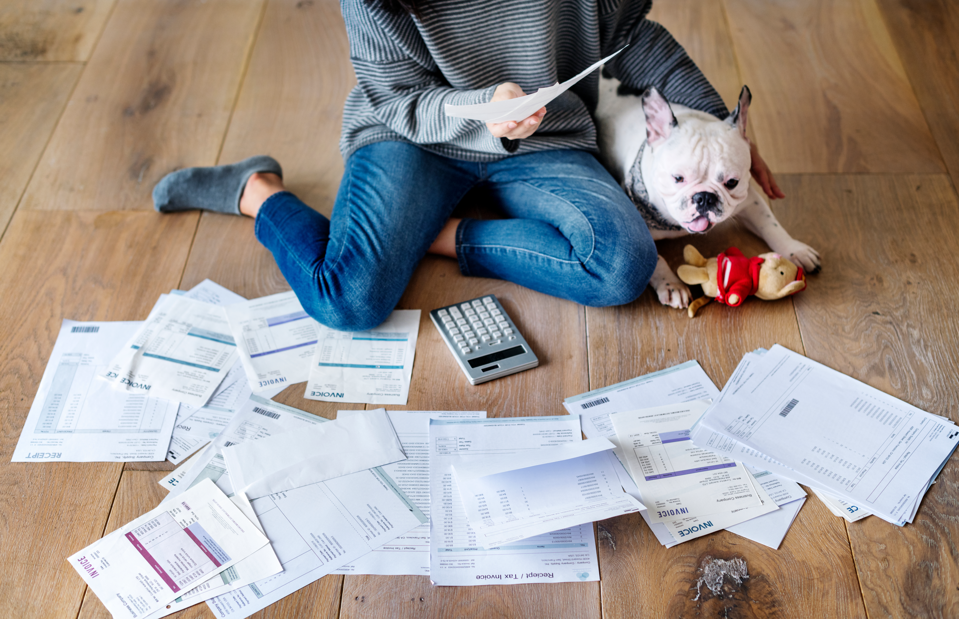 woman handling multple tax documents to keep her tax liability from compounding