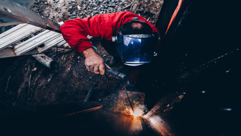 A welder welding at a construction site.