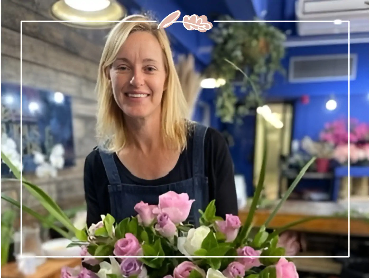 A happy florist at Fabulous Flowers and Gifts showcasing a bouquet of pink and white flowers. Your Perfect Bouquet of Flowers ready for clear vases and your loved ones.