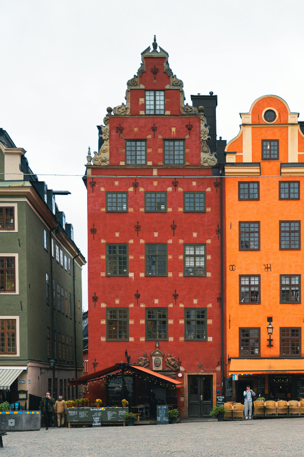 A beautifully preserved red townhouse in Stockholm’s old city, embodying Scandinavian design elegance and craftsmanship that inspires emerging designers, exhibitions, and industry talks during Stockholm Design Week and the furniture fair.