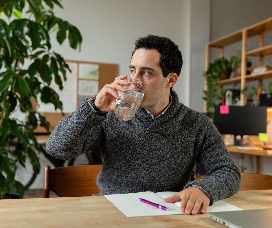               A person drinking a glass of water, symbolizing the replacement of alcohol with healthier alternatives