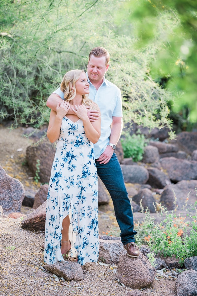 A woman twirling in a flowy dress, demonstrating movement for engagement photos.