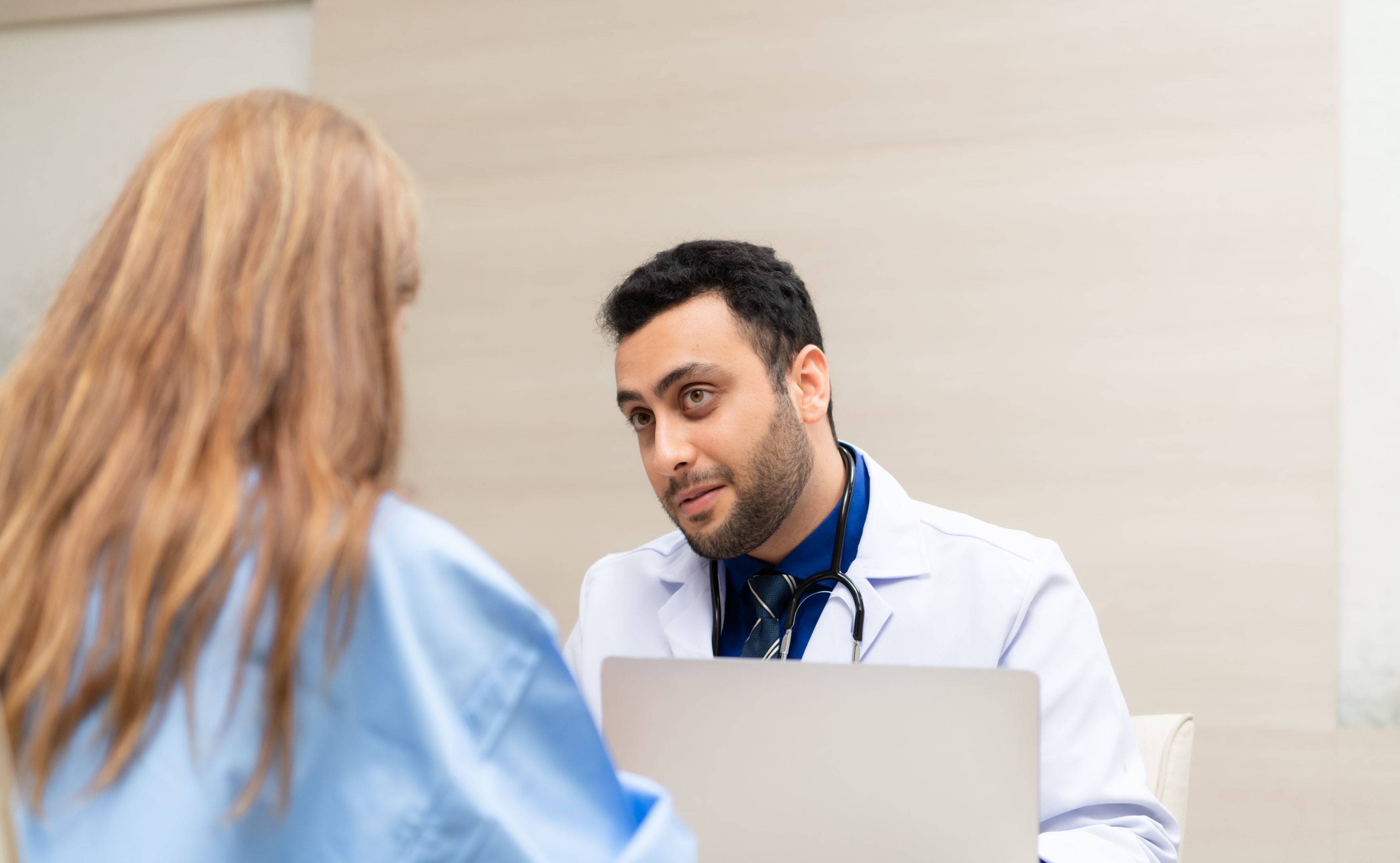 an oral surgeon speaking with a patient about dental implant surgery and different dental implant options available