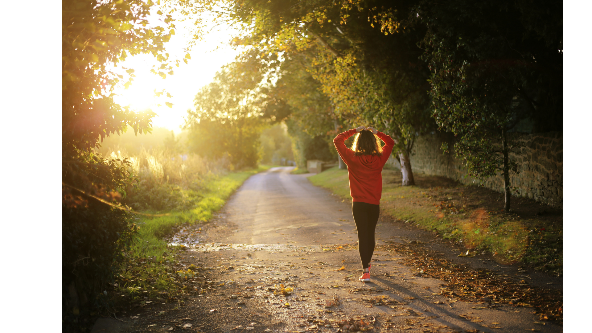 Girl talking a walk on a trail with her arms up.