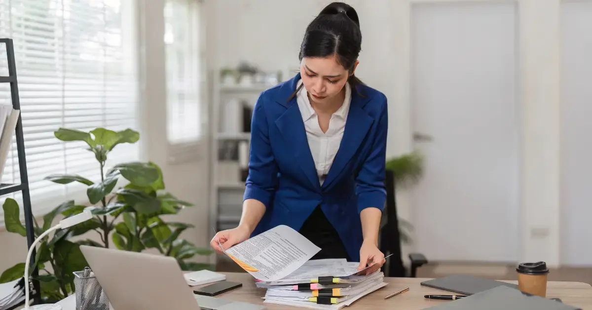 Woman reviewing IRS documents for audit defense and OnlyFans tax compliance.