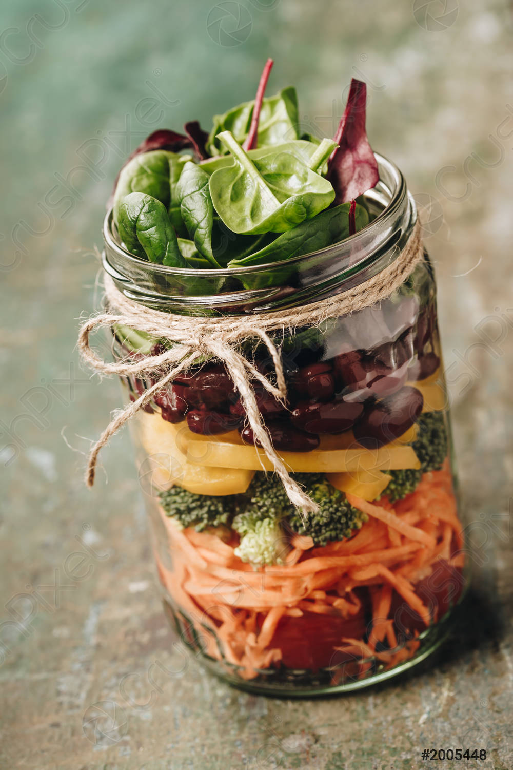 Mason Jar Salad with lettuce, olives, shredded carrots, peppers, and broccoli