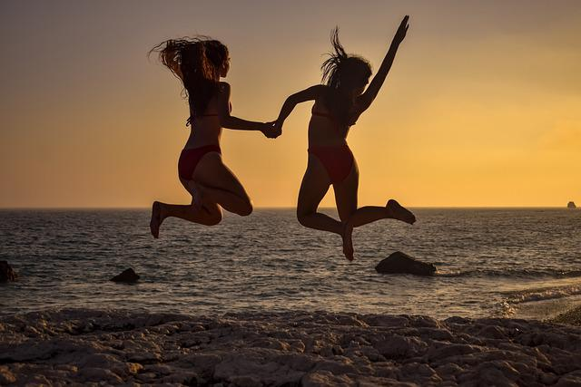 girls, jumping, beach