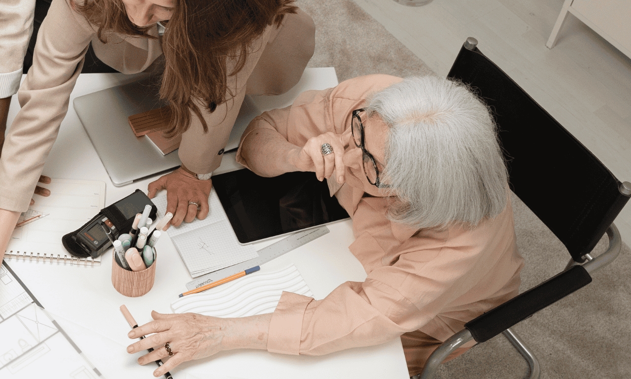 An older strong woman dictating what is happening in the office.