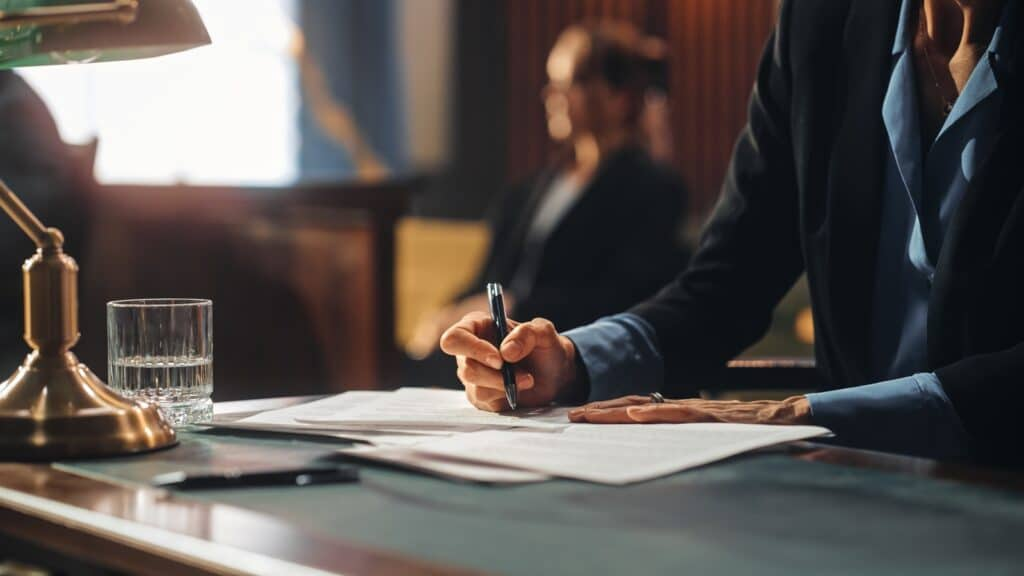 Attorney reviewing legal documents in a courtroom setting, emphasizing the importance of understanding assault and battery charges in Texas law.