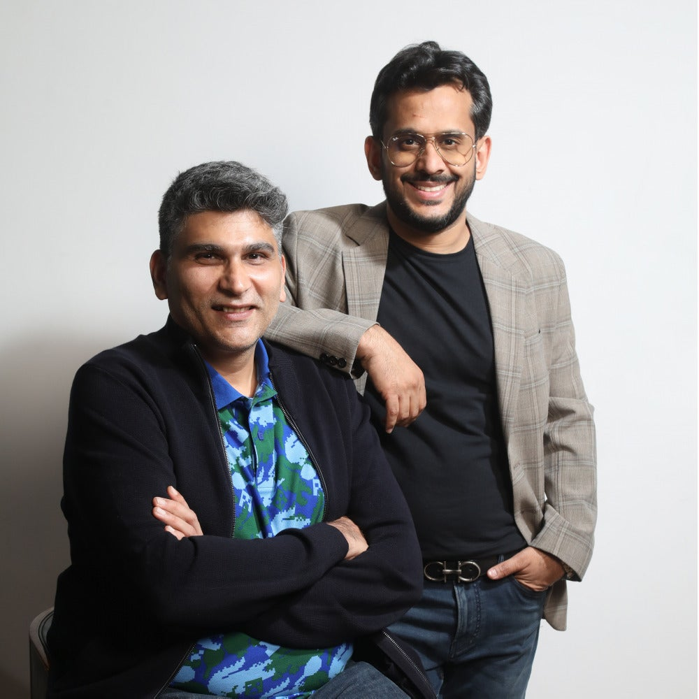 The image shows Sameer Mehta and Aman Gupta together