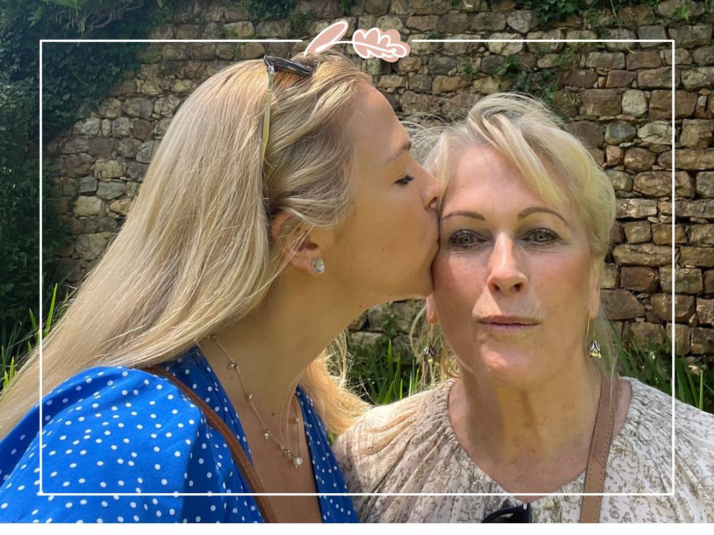 Mother receiving a kiss on the forehead from her daughter during an outdoor adventure. A tender moment showcasing affection.