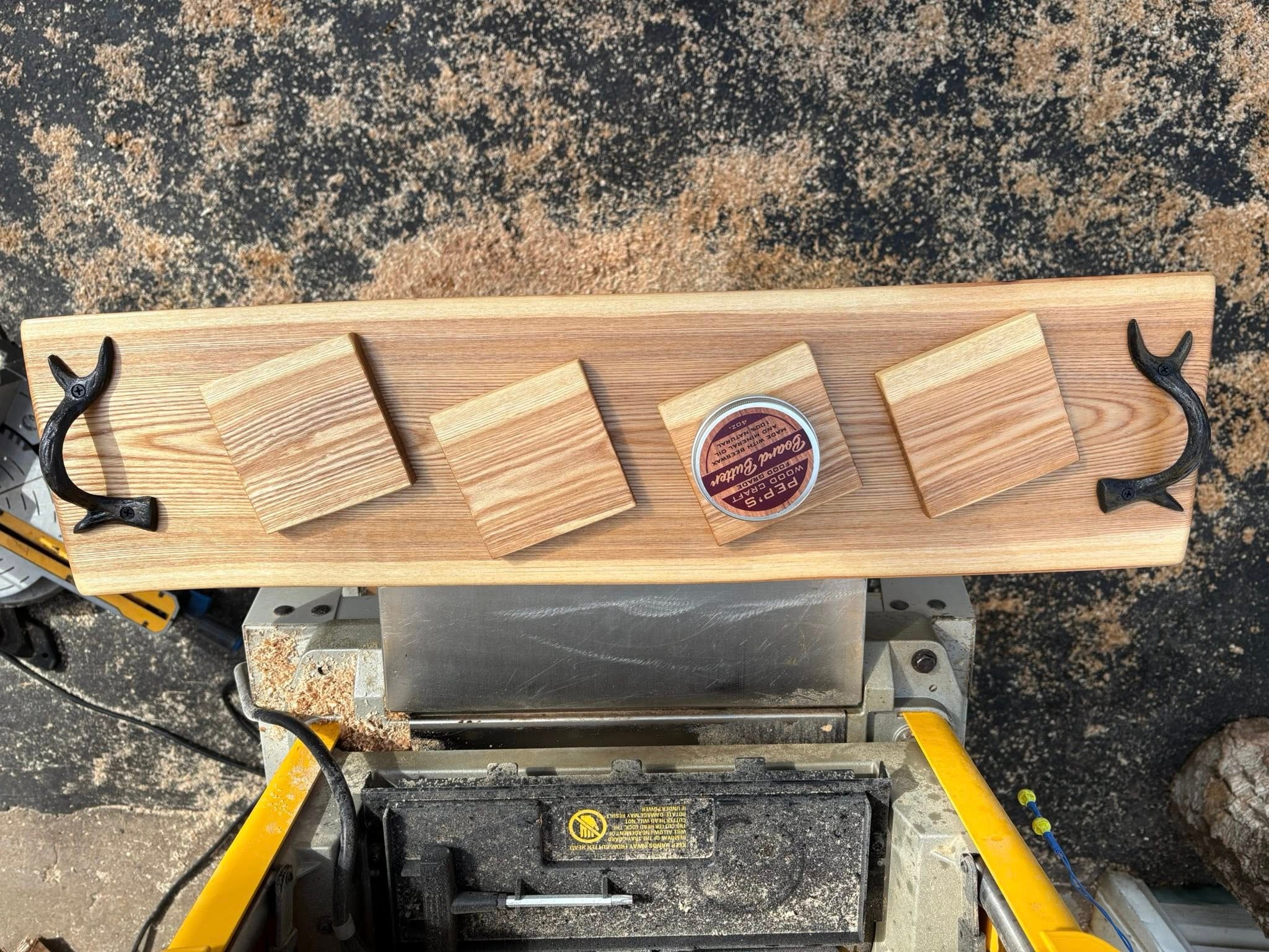 Wooden coasters on a slab cutting board. Coasters are great for new woodworkers with a low skill level and are low cost to make.