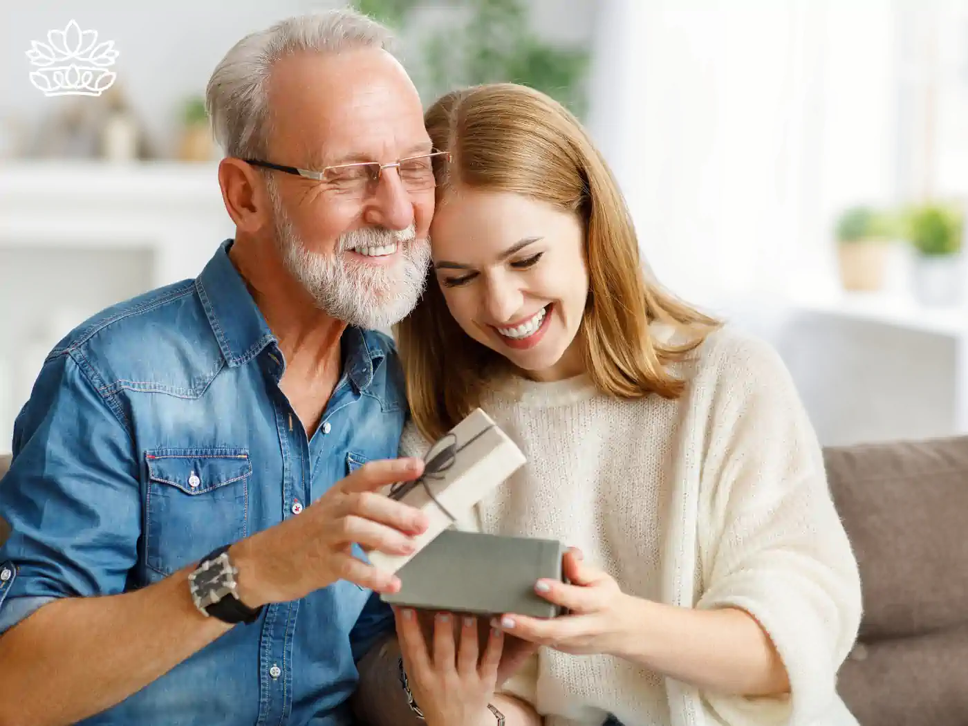 A happy elderly man and young woman unboxing a luxury gift together - Fabulous Flowers and Gifts, Luxury Gift Boxes collection.