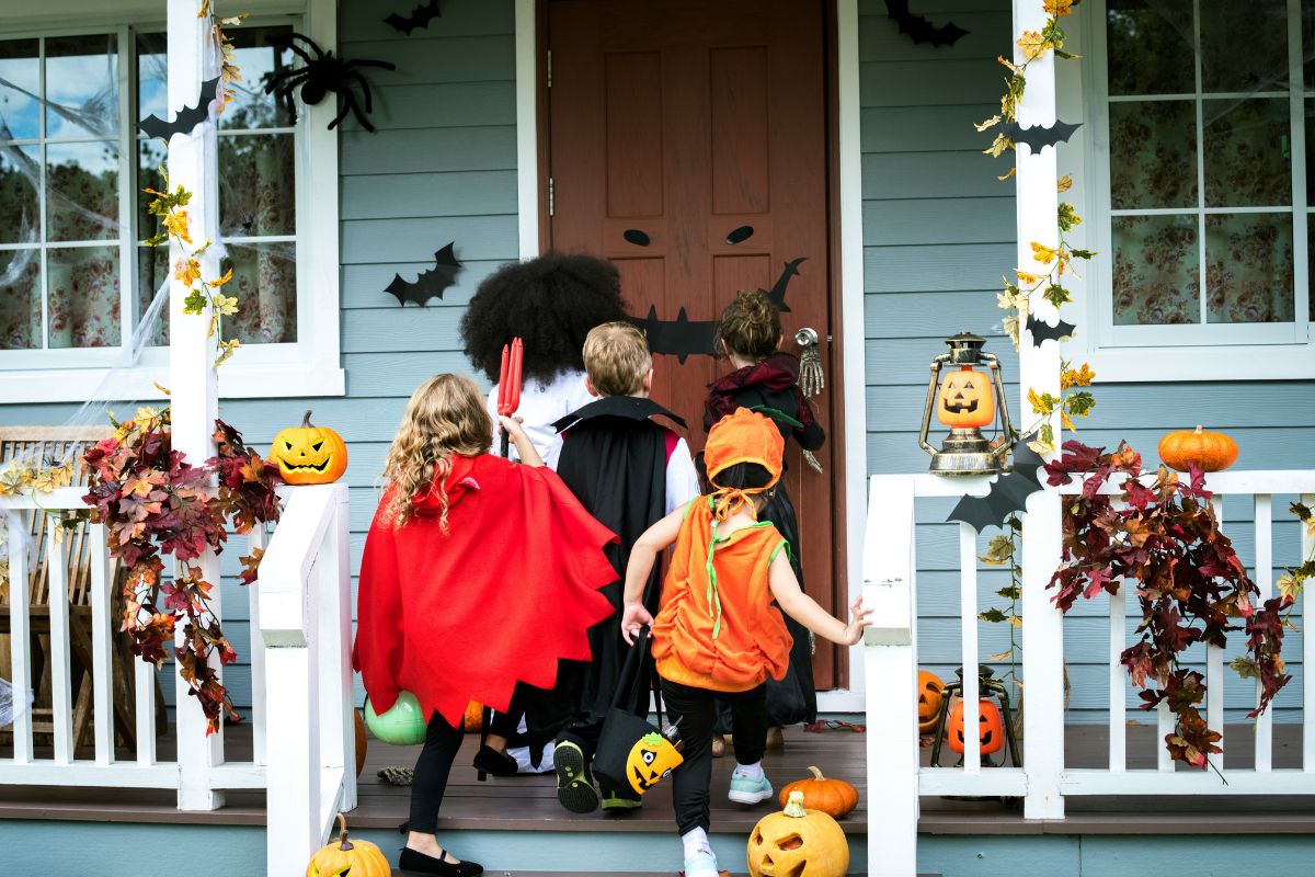 A kid-friendly Halloween porch decorated with fun and bright elements.