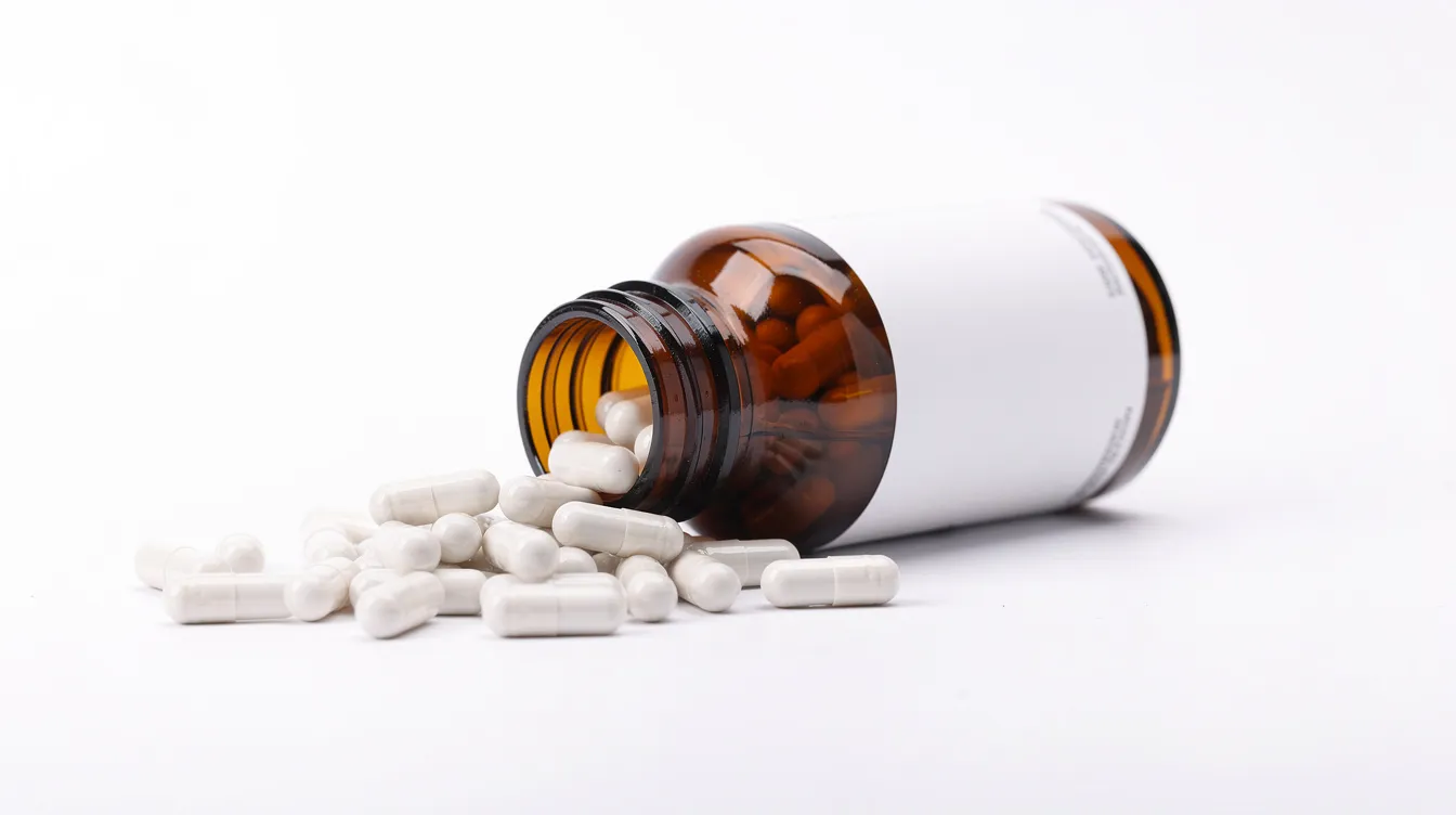 The image features an amber supplement bottle filled with white capsules, some of which are spilling onto a clean white surface. This nicotinamide riboside (NR) supplement is designed to support cellular health and energy production, promoting healthy aging and mitochondrial function.