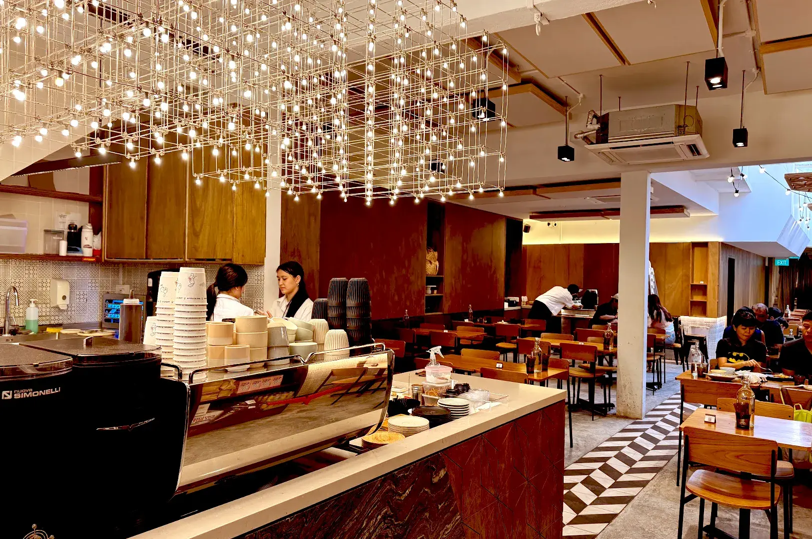 Elegant interior of Apricus Coffee & Food Co. at Jalan Kayu, featuring warm lighting and a refined atmosphere for premium halal brunch and coffee.