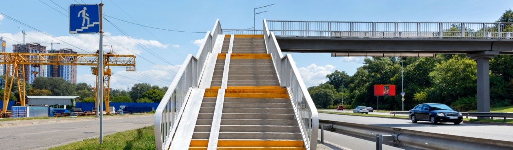 Comprehensive pedestrian safety programs in NJ include overhead pedestrian crossing structures to prevent accidents.