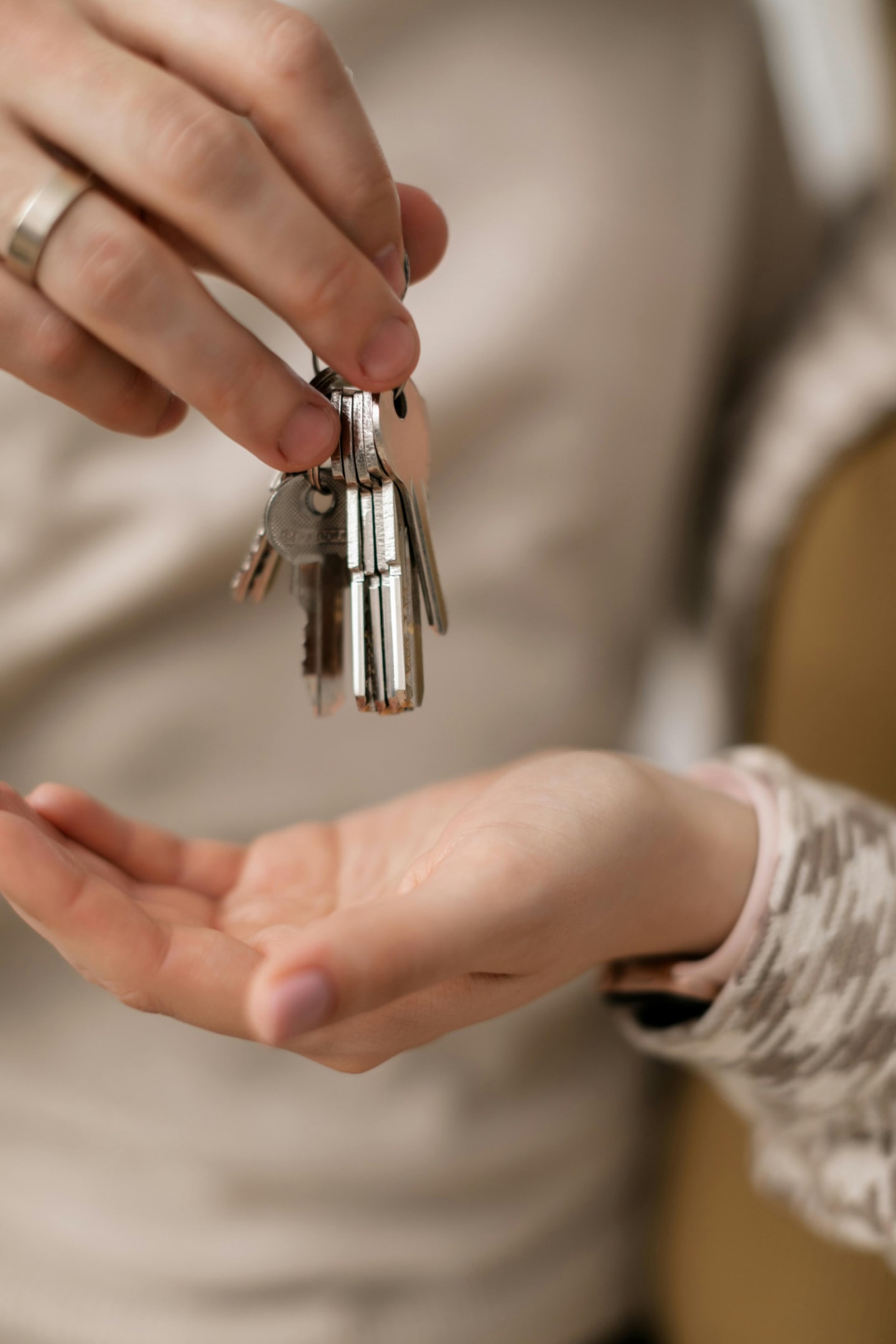 Keys being passed from investor to buyer after a successful fix-and-flip on a property.