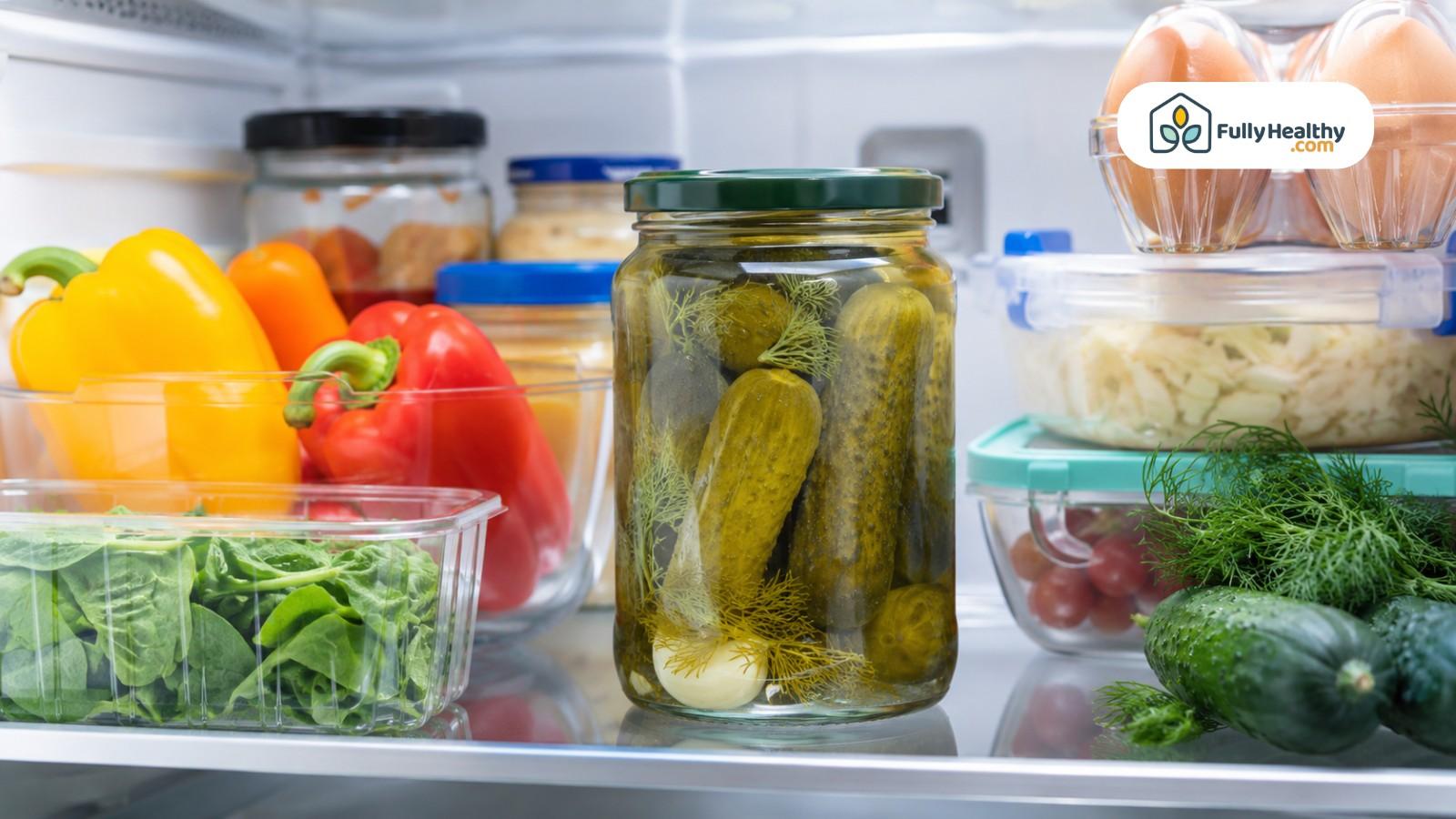 Sealed pickle jar stored in refrigerator beside fresh vegetables and food containers