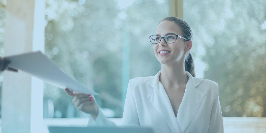  Businesswoman doing paperwork in office