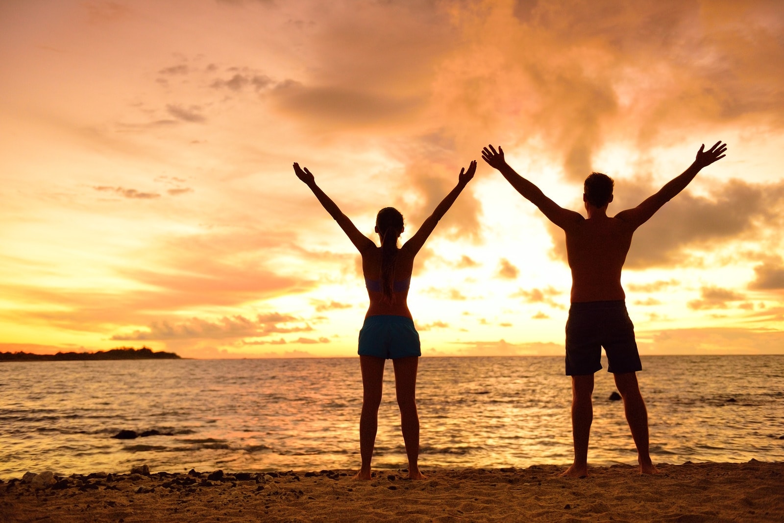 Couple enjoying sunset at the beach