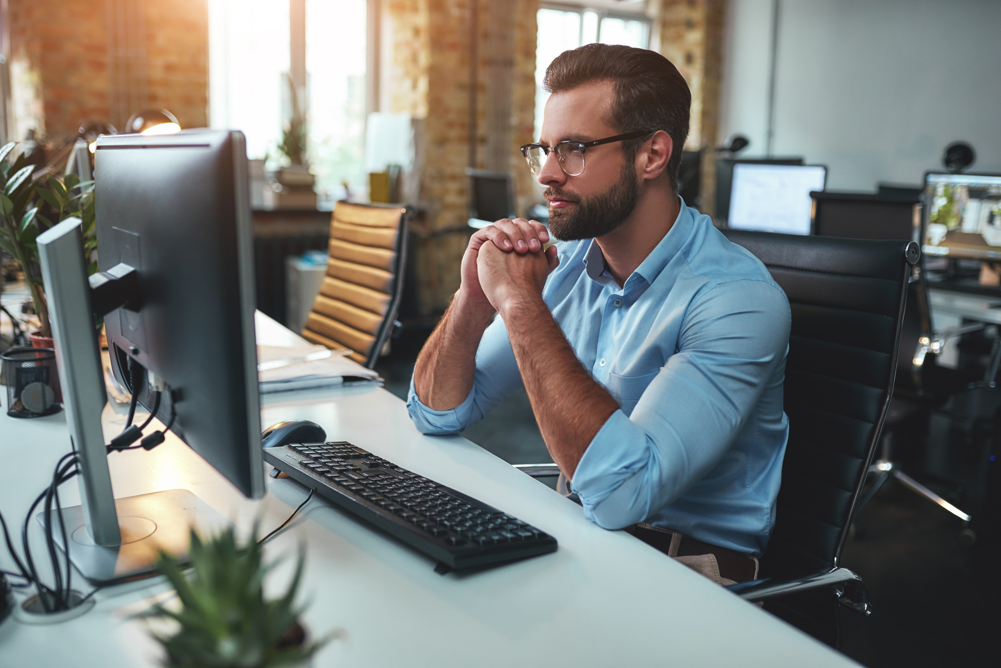 Man thinking at a computer