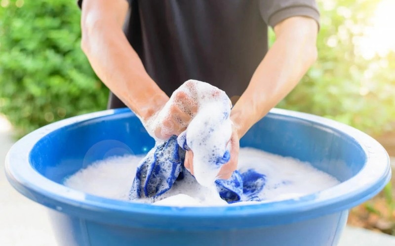 A person rinses a microfiber cloth.