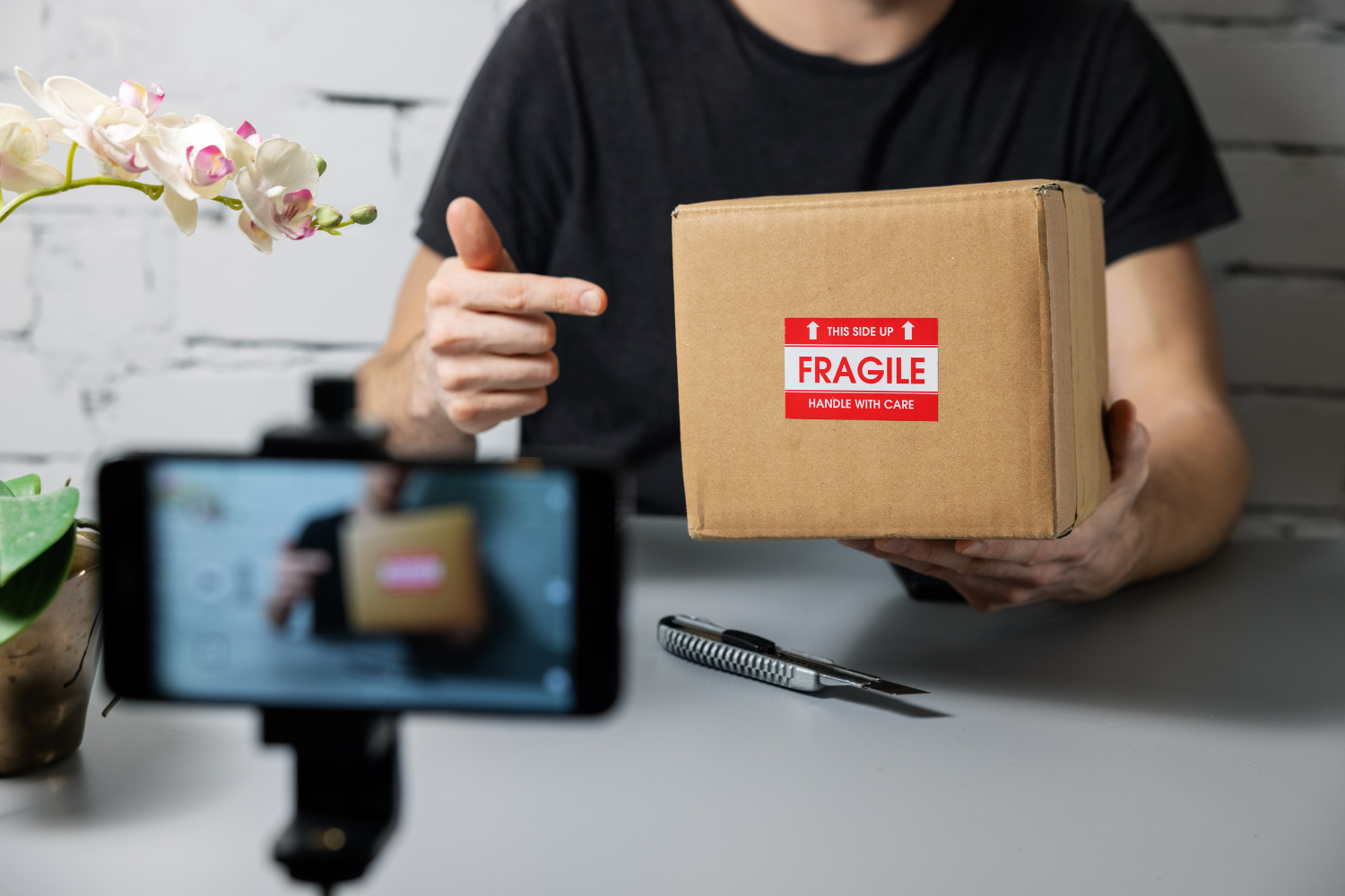 A fitness influencer recording a supplement unboxing video.