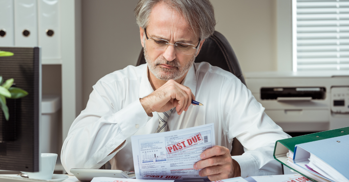 An image of a person looking at past due bills.