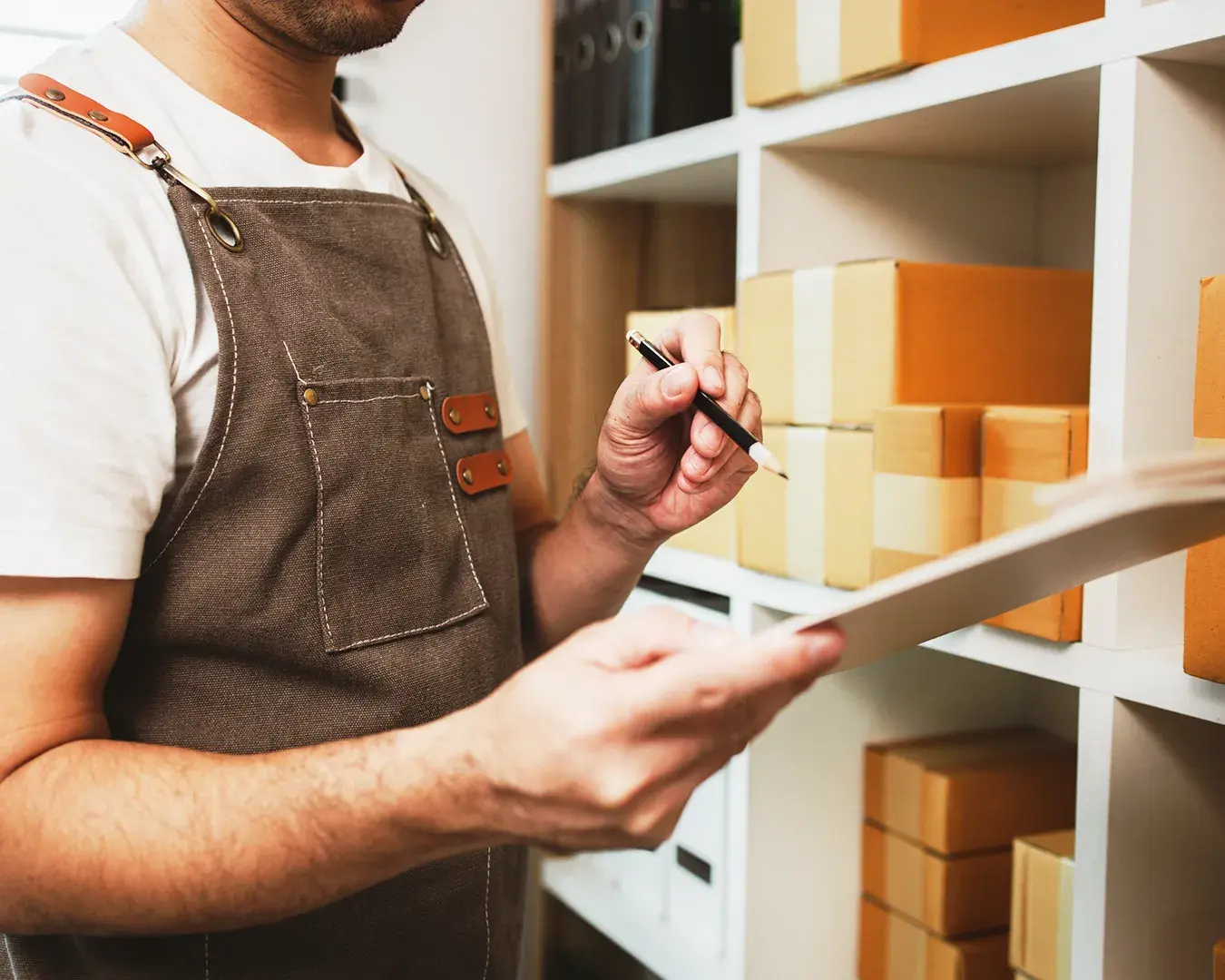 Small business owner managing inventory and product stock using a POS system
