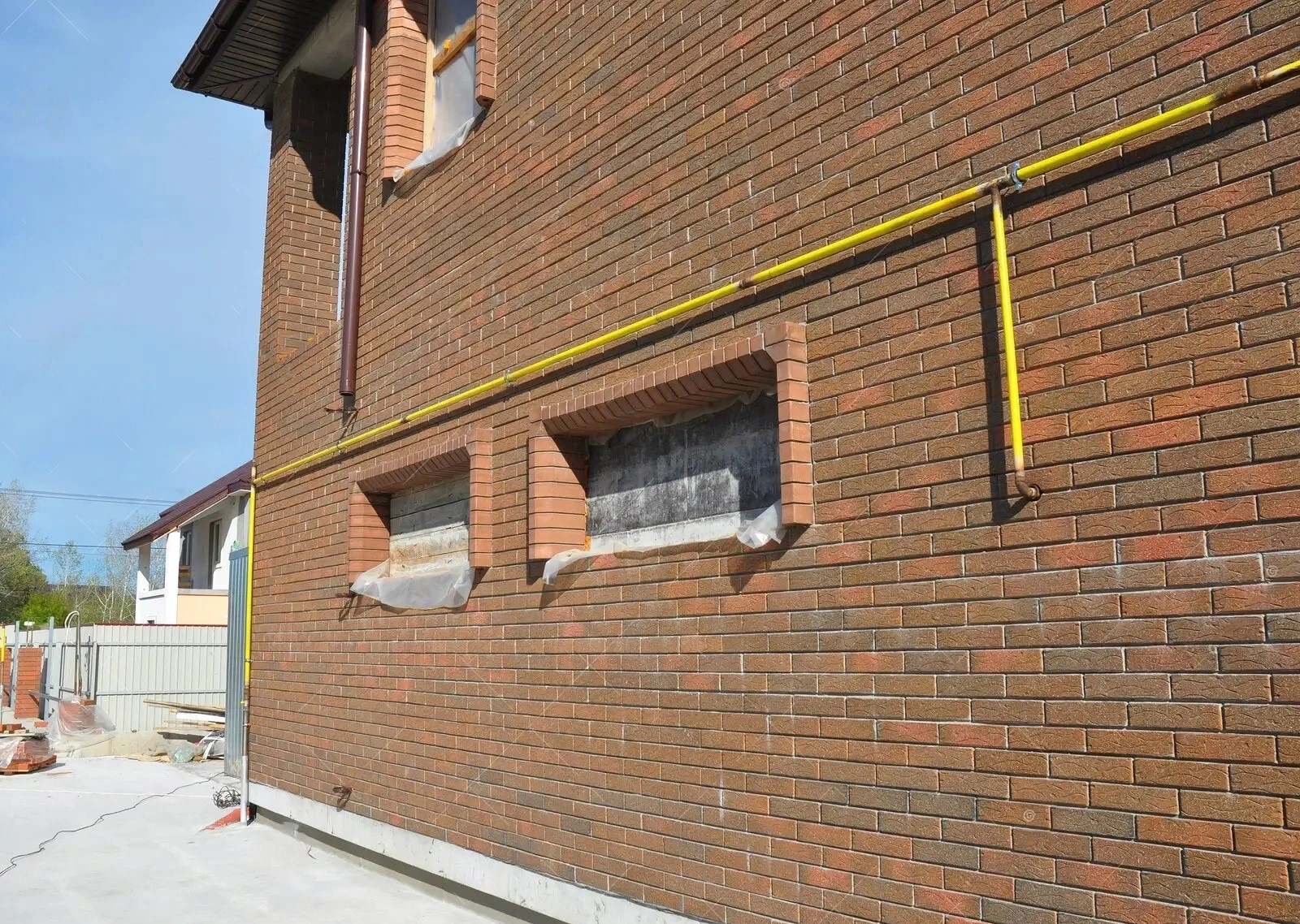 Gas line along exterior wall of a house