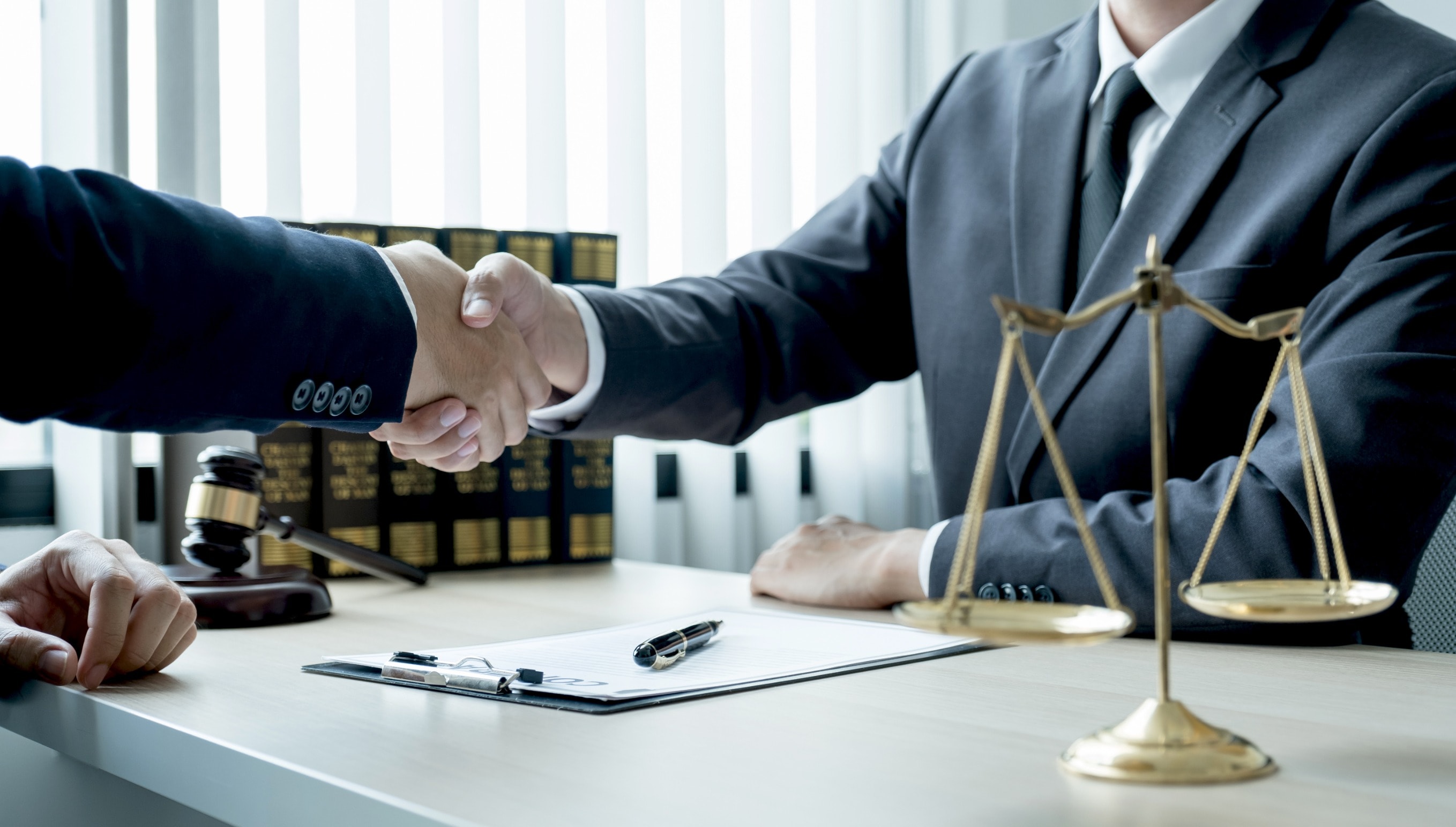 A personal injury claims solicitor shaking hands with a client