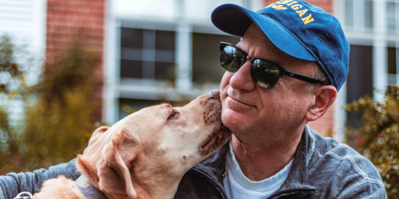 Dog licking his owner with love