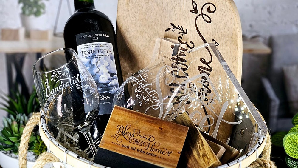 gift basket with wine bottle, custom engraved wine glasses, cutting board, and more by Nicki Piland 