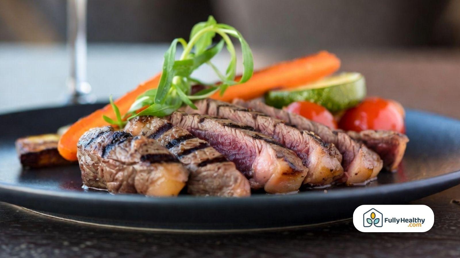 Grilled kosher beef steak served with fresh vegetables on a modern dinner plate.