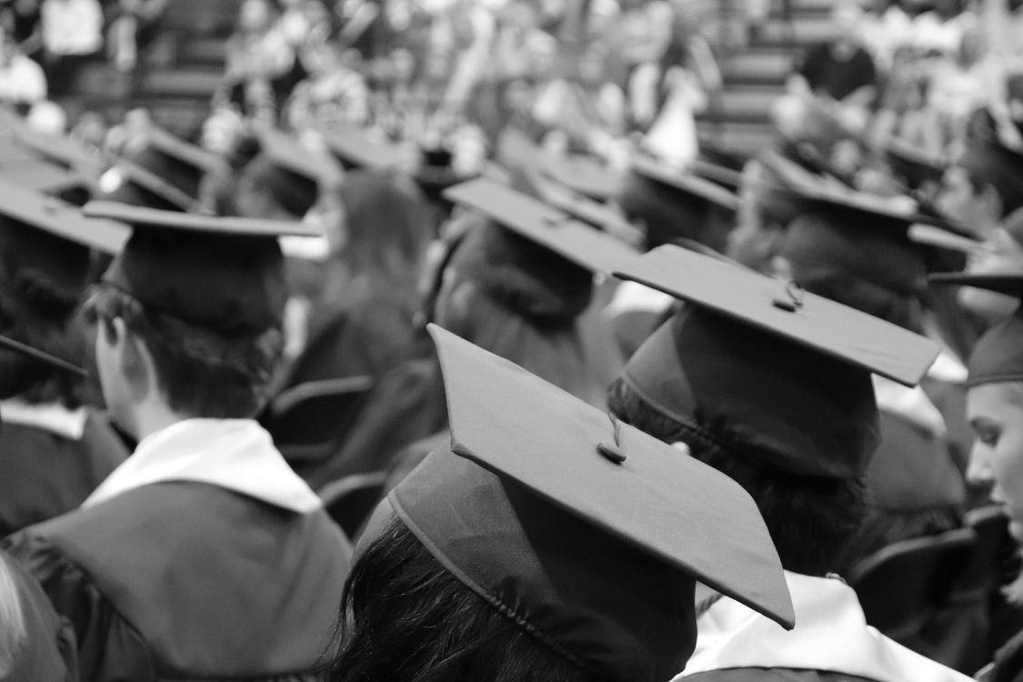 Group of Filipino students in caps and gowns at a graduation ceremony