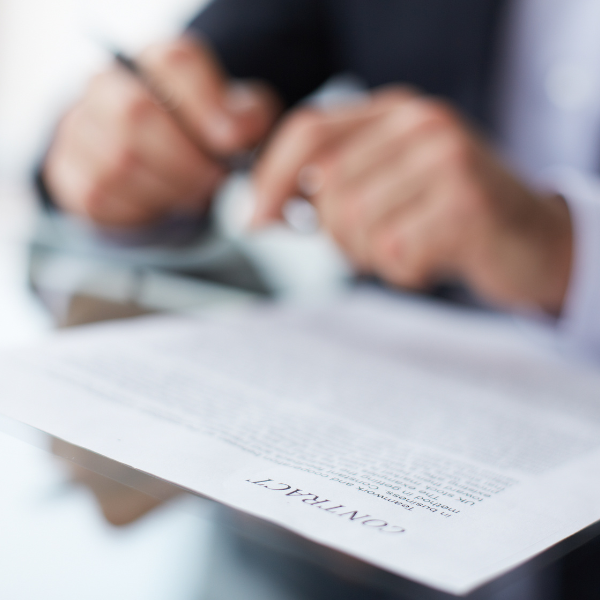 A photograph showing a contract with contingency fee terms highlighted.