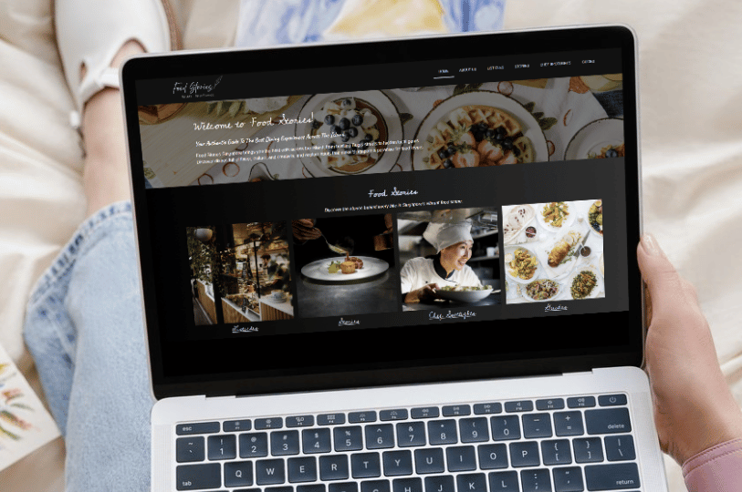 A close-up of a laptop screen showing the "Food Stories" website, an example of a content-rich restaurant blog or landing page designed to attract organic search traffic.