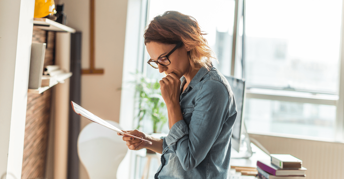 An image depicting a person reviewing their life insurance policy.